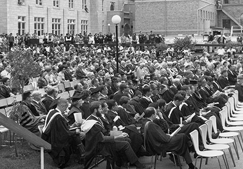 Black and white early convocation photo - audience in seats on front lawn