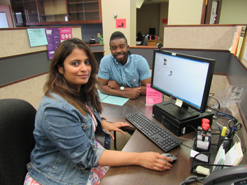 Staff member and student with ID card on screen. (Photo credit: Lois Cherney)