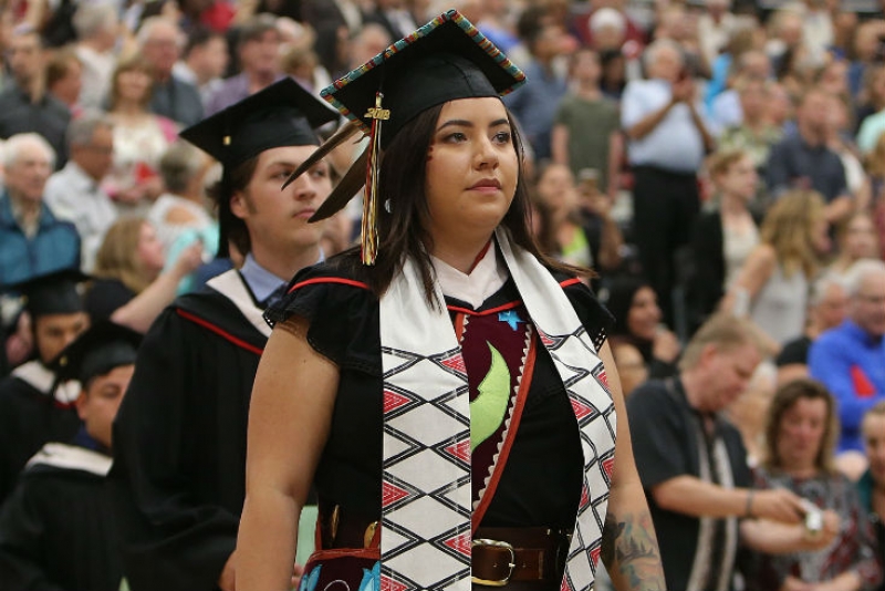Graduate Sarah Delaronde in cap and traditional gown at graduation ceremony in 2018