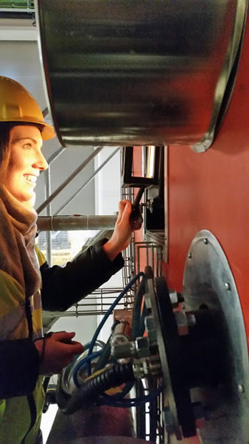  Shannon Baily looking at instruments in a biomass heating plant.