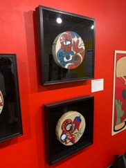 2 framed drums with spider-man painted on them in the style of Northwest Coastal Indigenous art