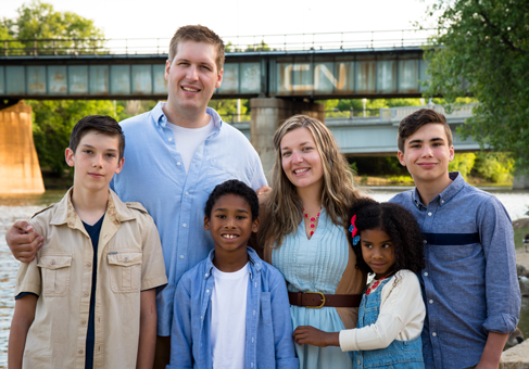 Jamie Pfau (centre) with her family, photo by Kristin Mallet.