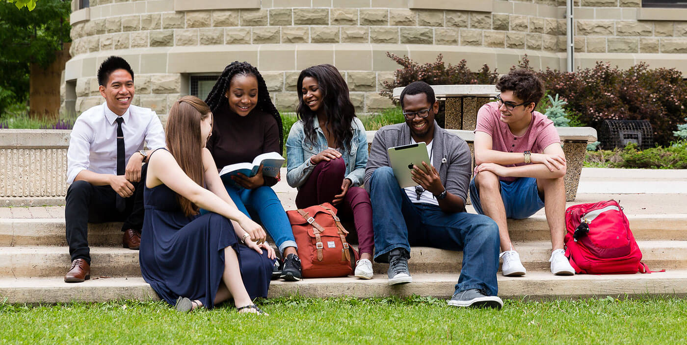 Students on steps in front of campus 