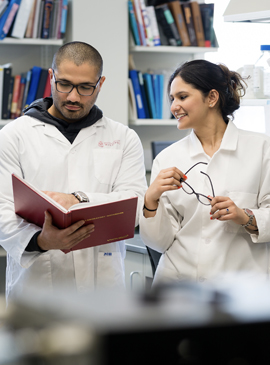 Two Graduate Studies students in a lab