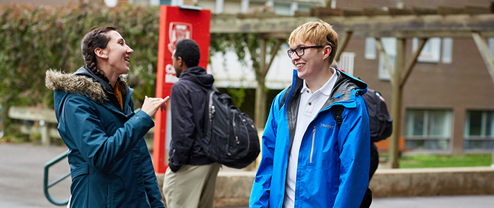 Student using sign-language with another student.