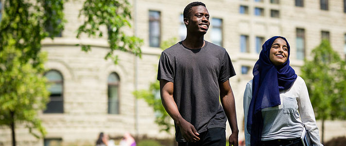 Students stand on grounds in front of Wesley Hall