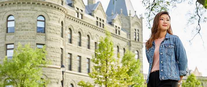 Student stands in front of Wesley Hall