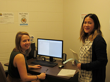 AS invigilators at a computer in a testing room