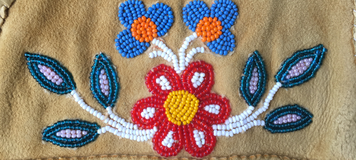 beaded flowers on a leather vest