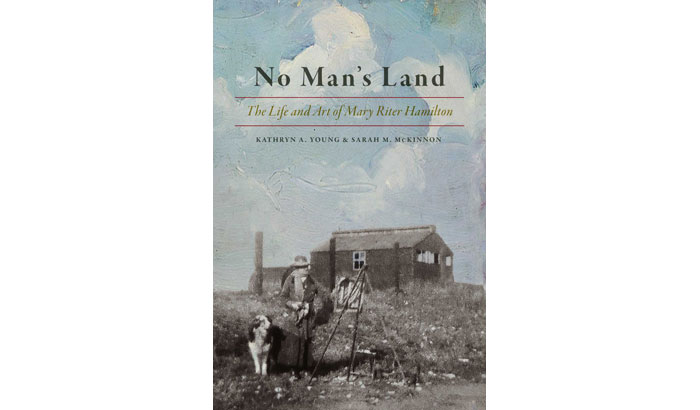 Book cover featuring black & white photo of woman painting outside in a field with buildings in background