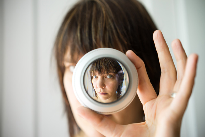 Woman as seen through the lens of a microscope.