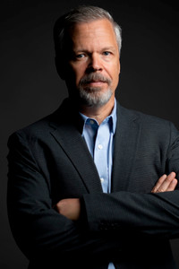 Dr. Derrick Nault standing against a dark background