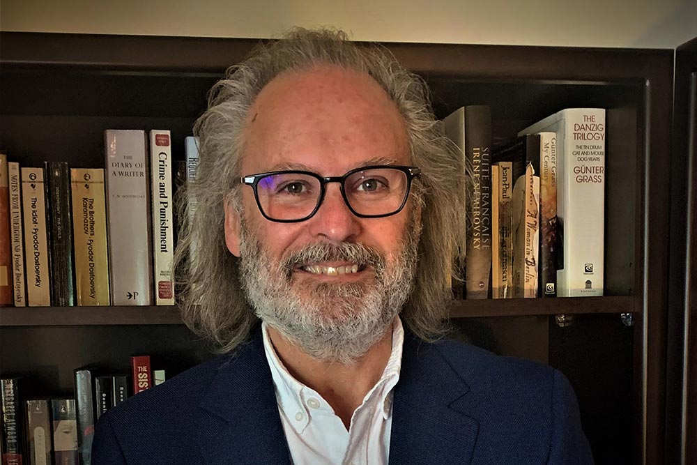 Dr. James Hanley's headshot against a bookcase