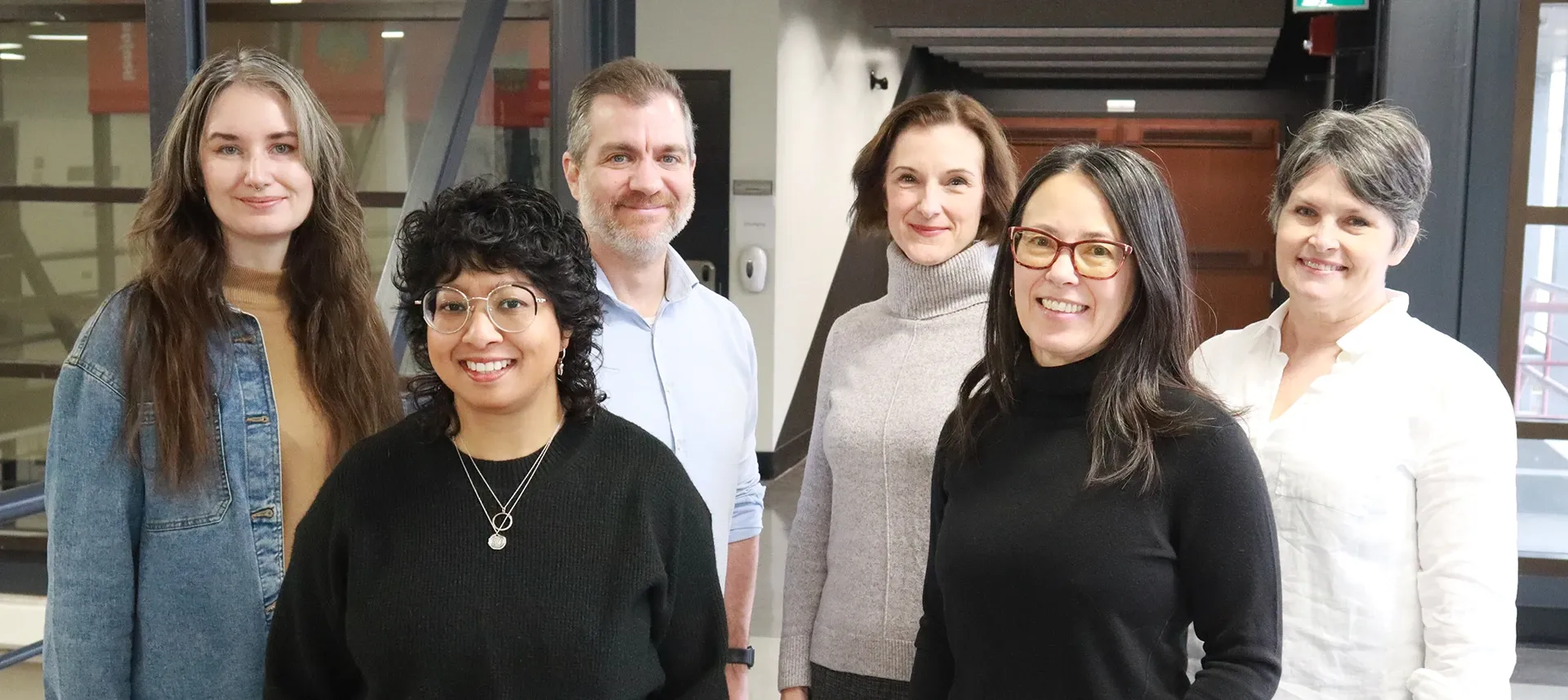 Group shot of six people smiling.