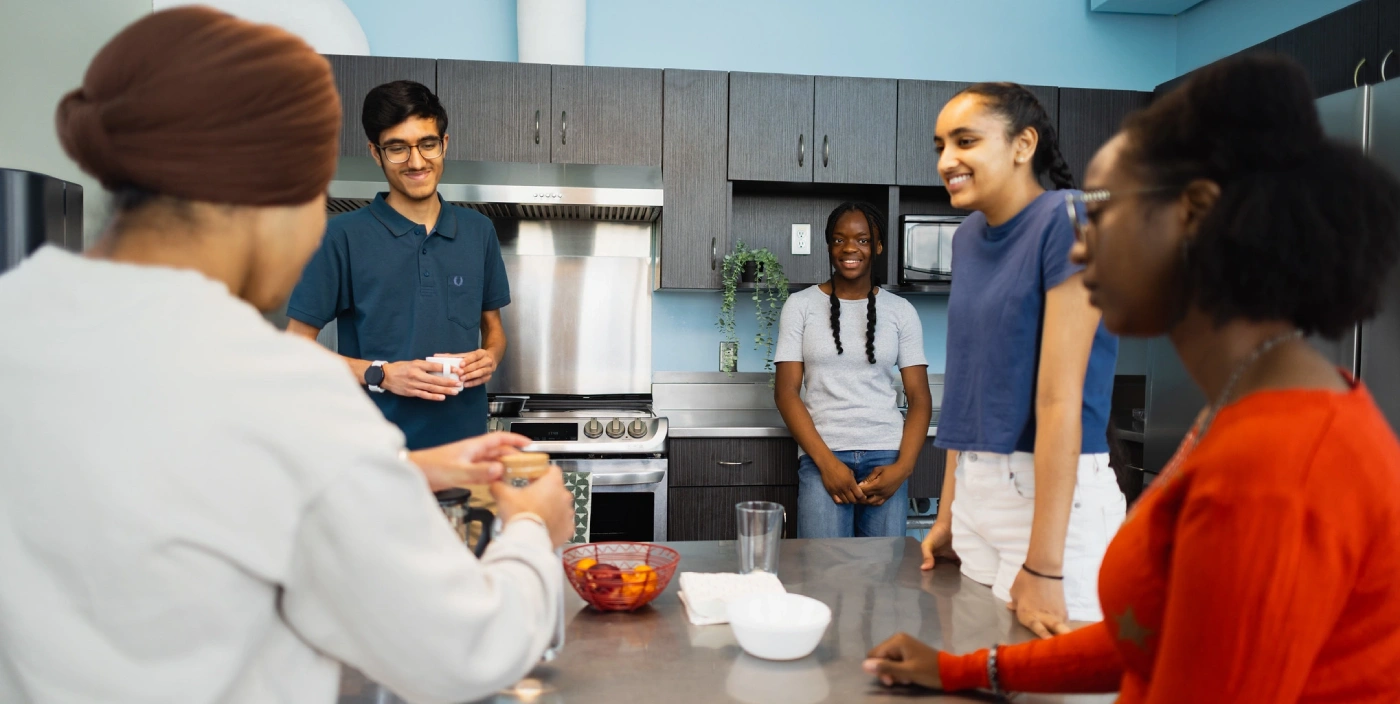 A student prepares a meal in McFeetors Hall's kitchen