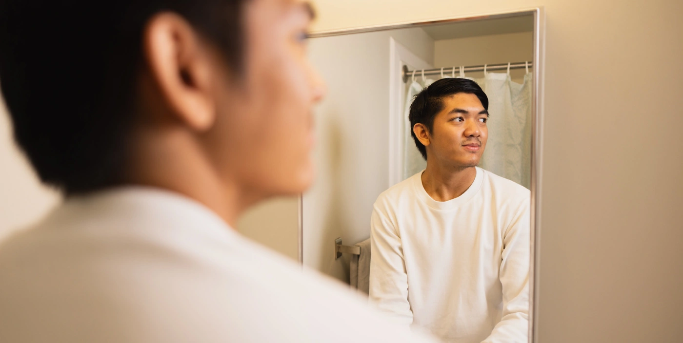 A student looks in the mirror in McFeetor's Hall