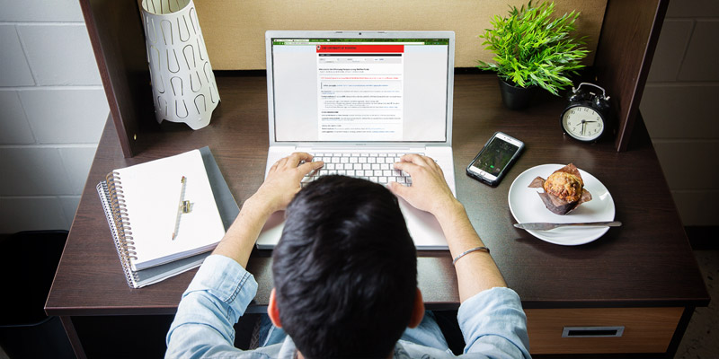 Person at a desk on a laptop