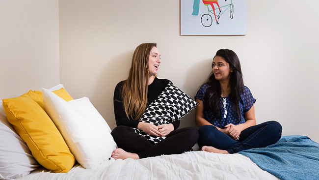 Students sitting in dorm room