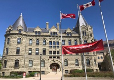 Wesley Hall with congratulation sign flying