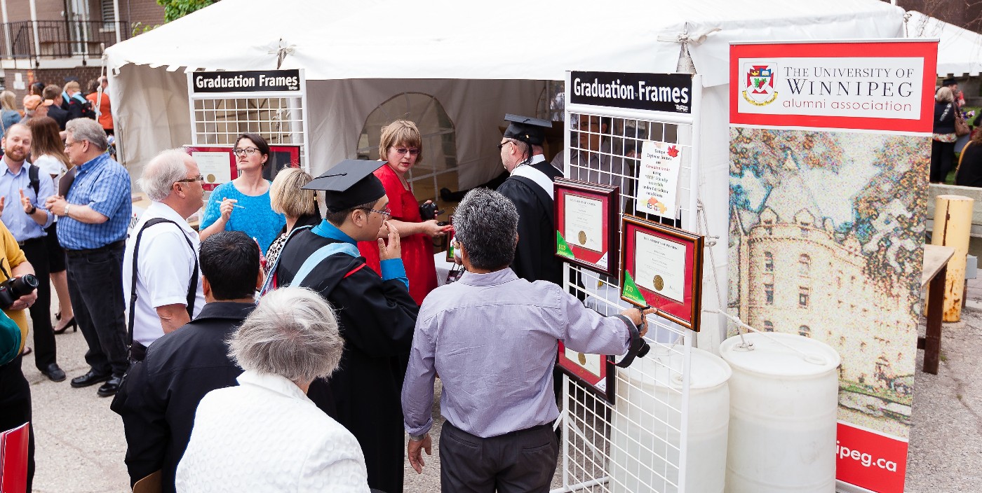 Family looking at degree frames