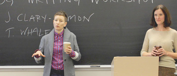 Angela Failler and Tracy Whalen in front of chalkboard addressing  a class