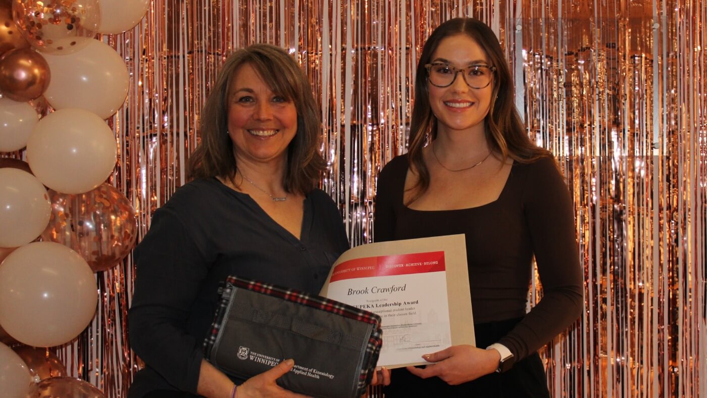 Student Brook Crawford holding the CCUPEKA Leadership Award