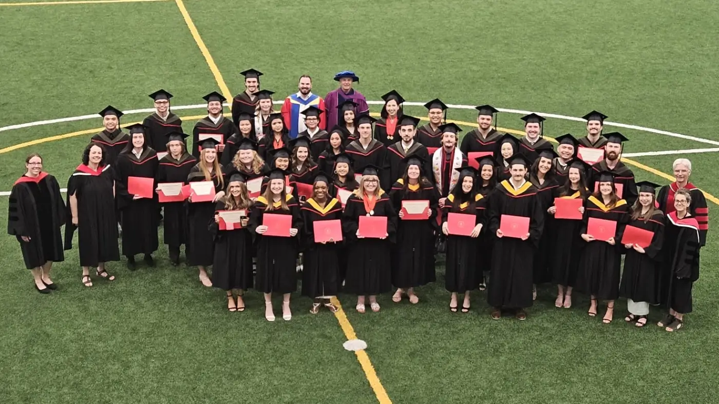 Kinesiology and Applied Health graduates on the RecPlex soccer field 