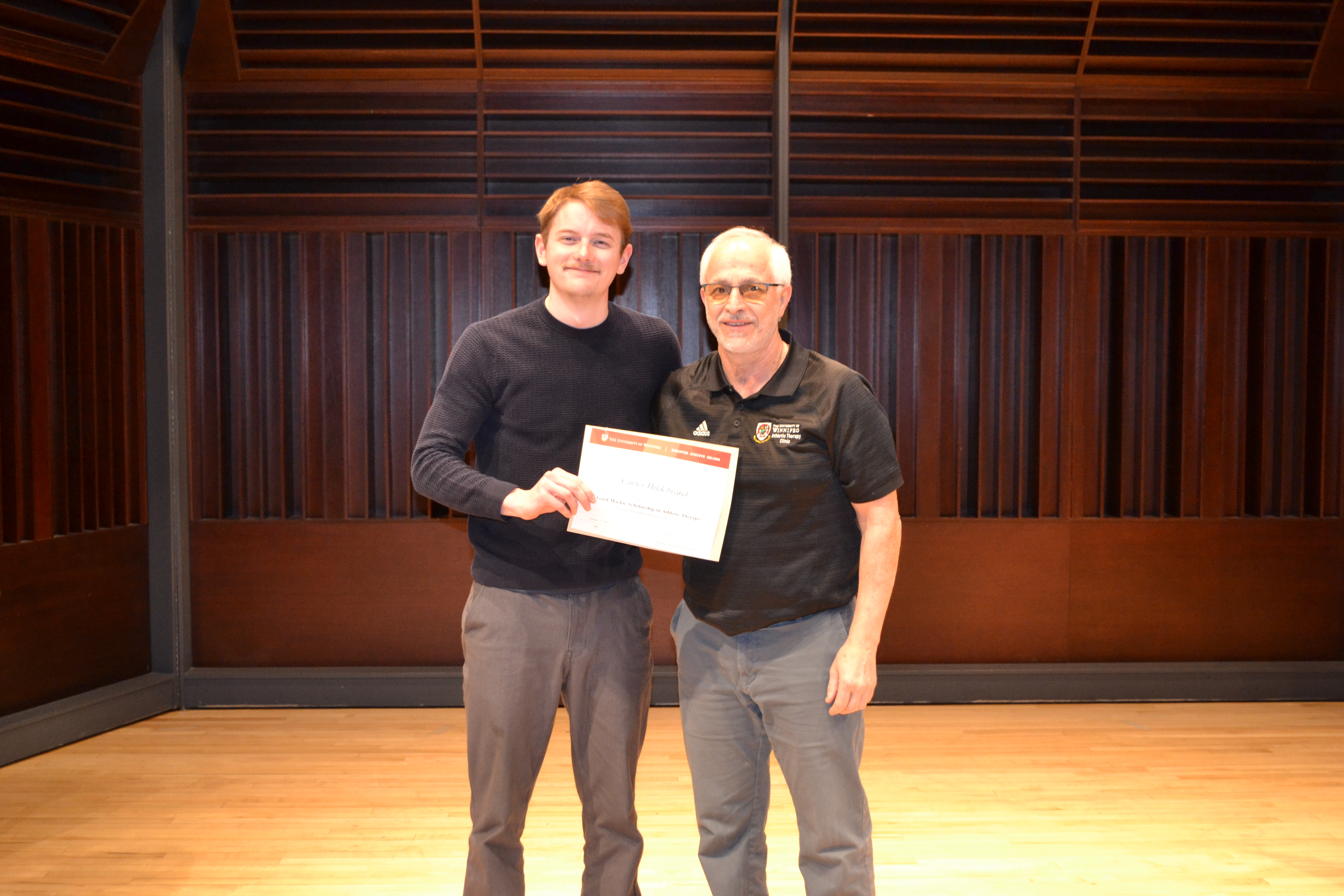 Faculty member Ben Trunzo presenting an award to Carter Hildebrand