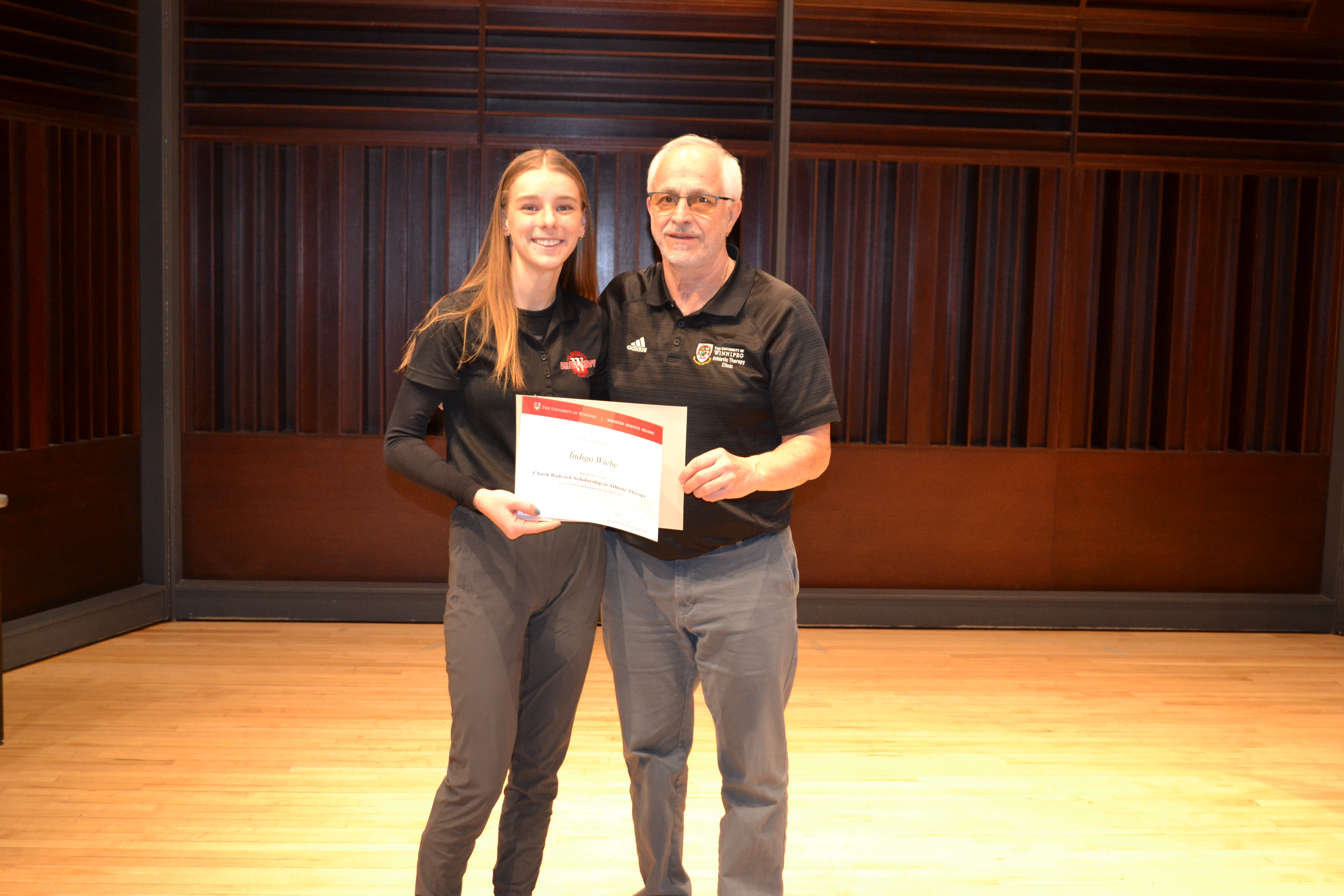 Faculty member Ben Trunzo presenting an award to Indigo Wiebe