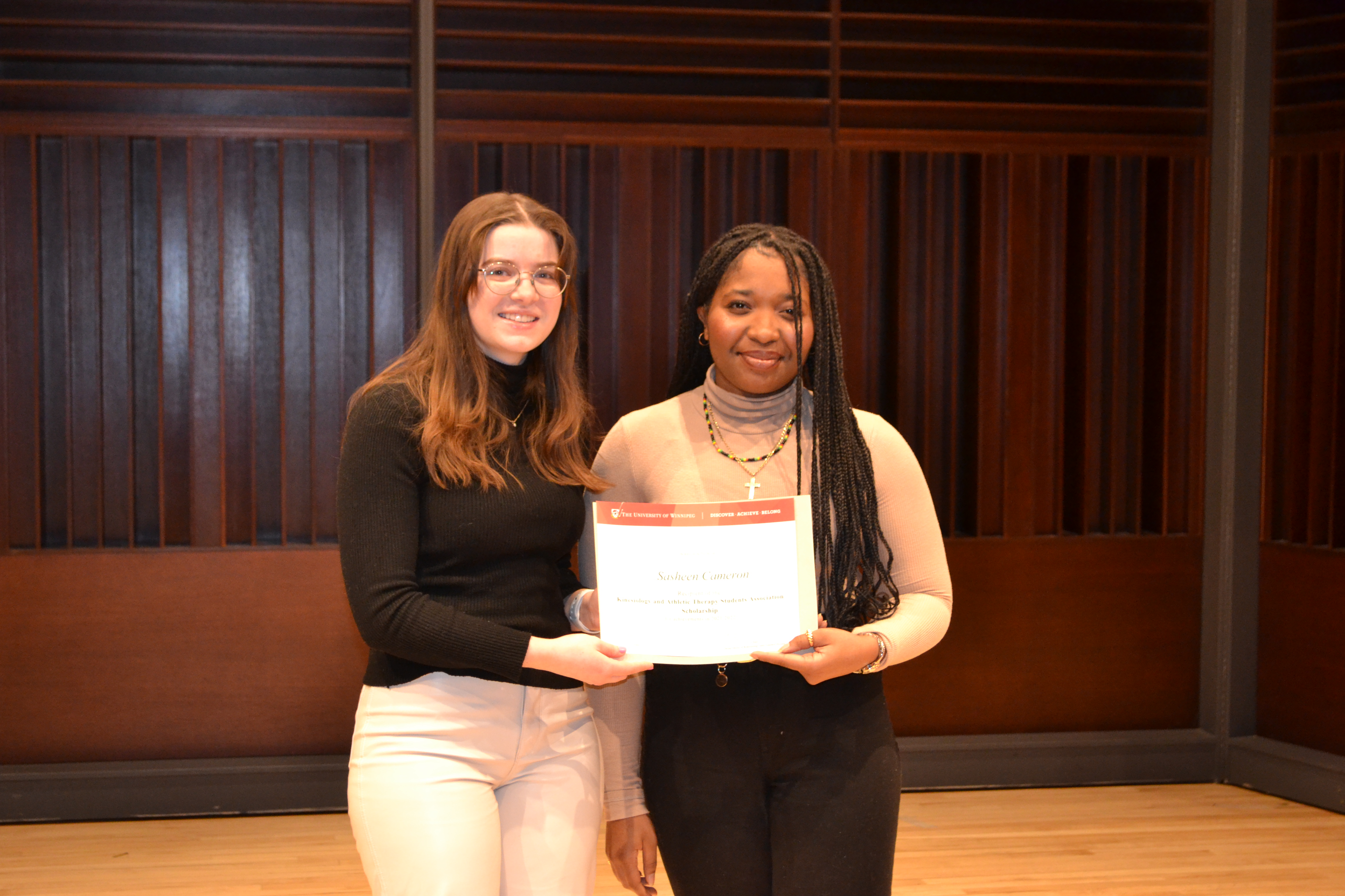 April Burnell, co-president of KATSA, presenting an award to Sasheen Cameron