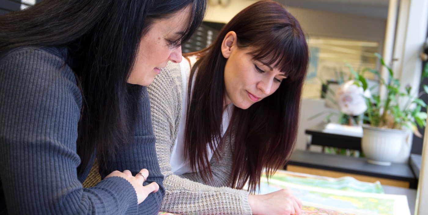 Students looking at a map. 