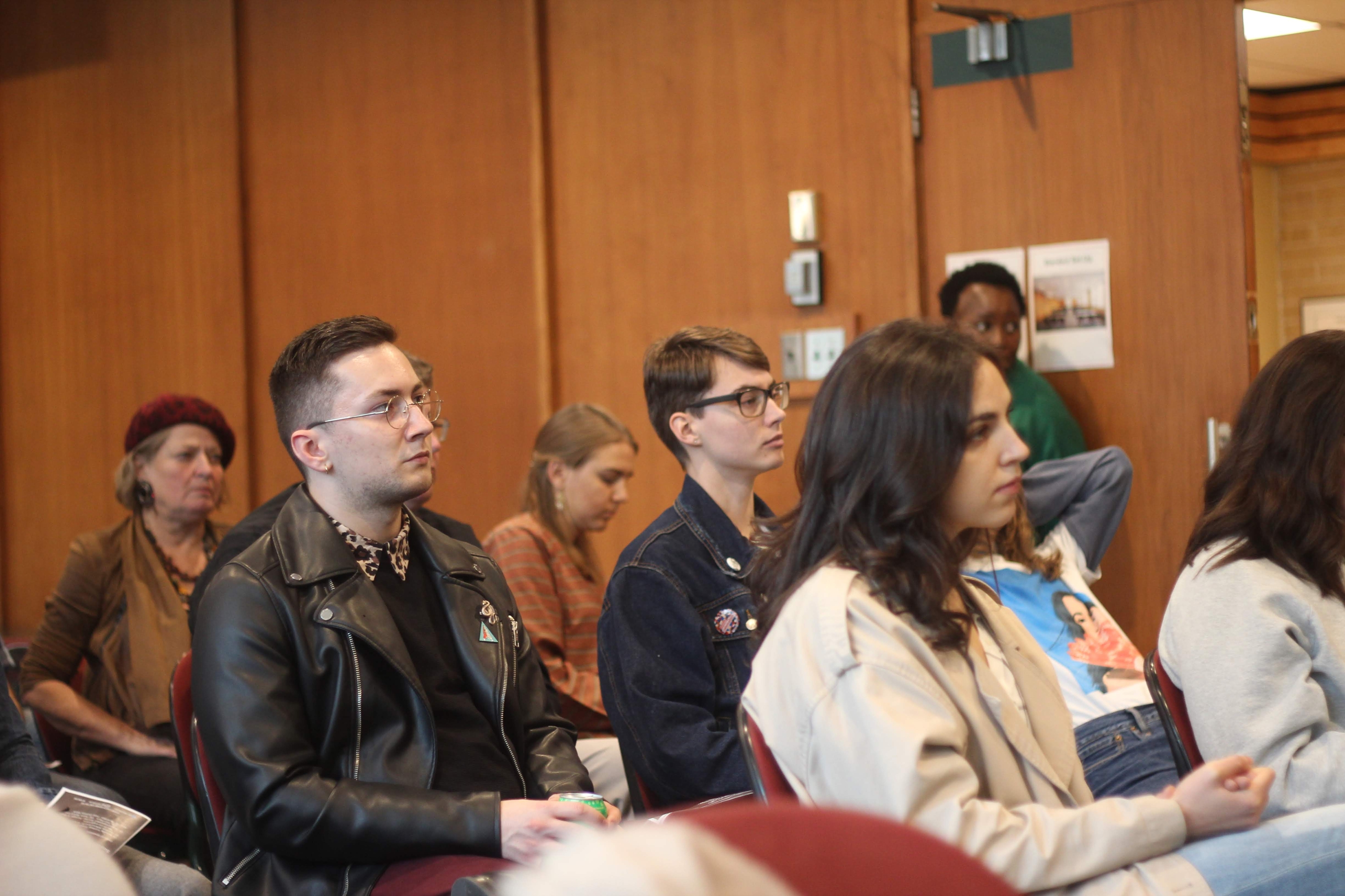 3 students sitting and listening