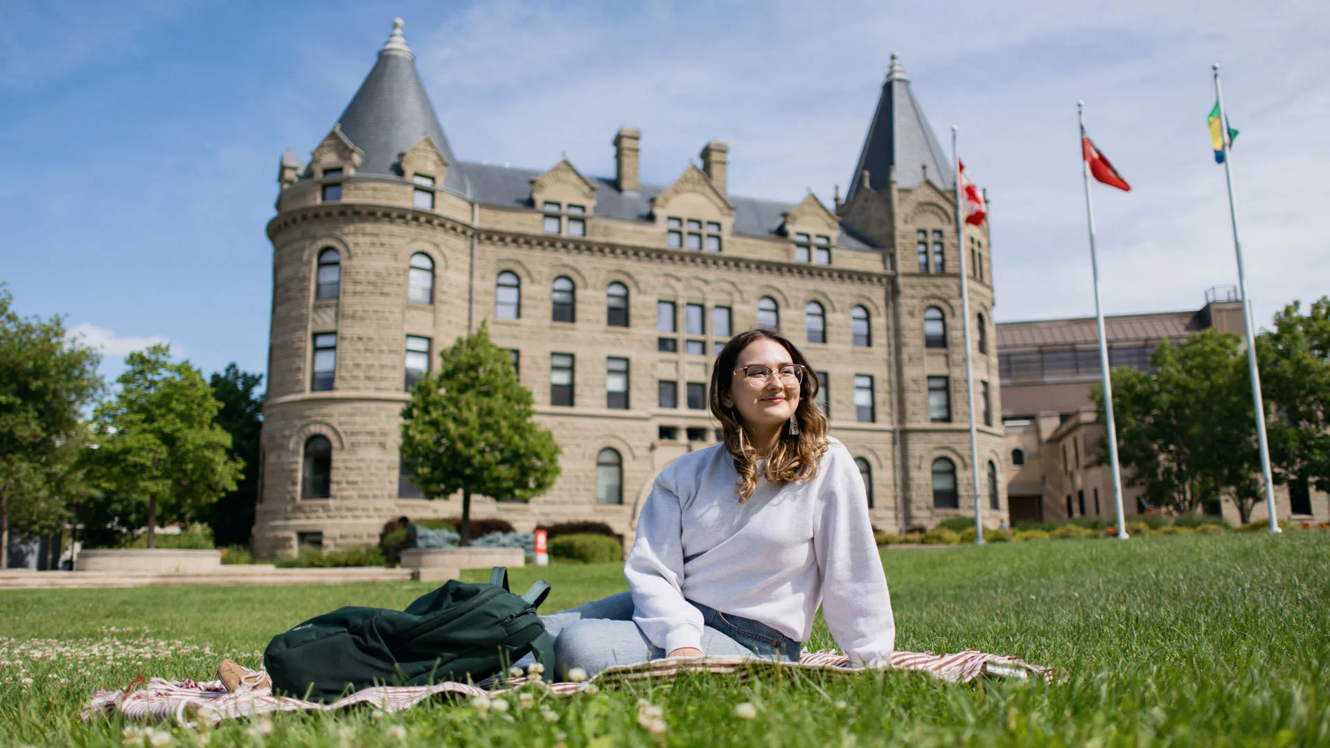 Student sitting on the front lawn