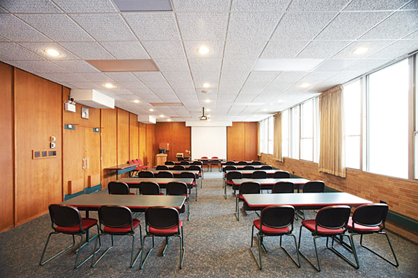 Inside the boardroom - several tables with three chairs all facing front