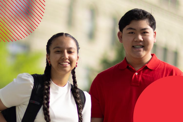 Two students outside looking at camera