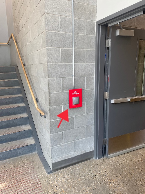 Arrow pointing to access point on concrete wall.