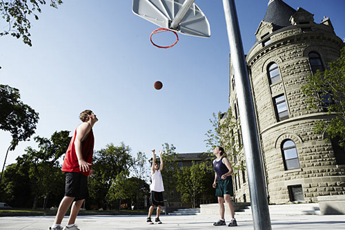 Students playing basketball outside