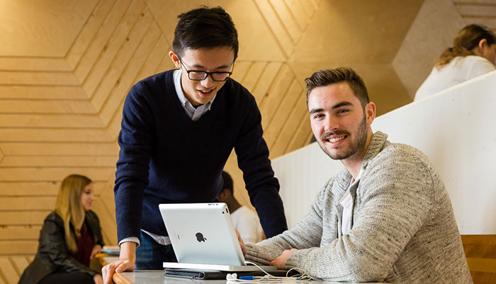 Two Students looking at a laptop