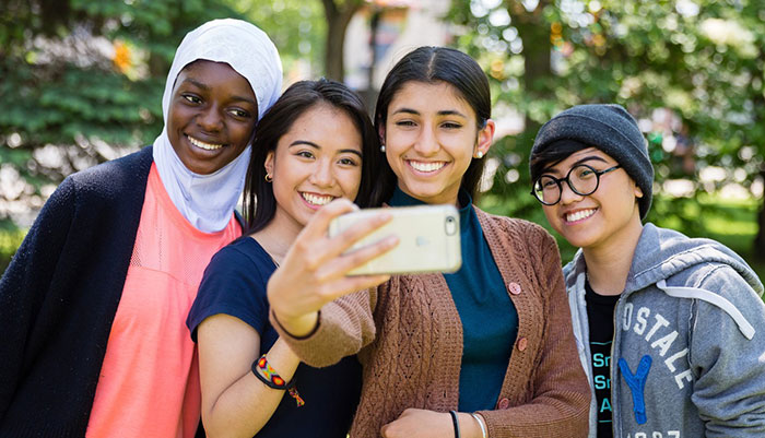 Four students taking a selfie together