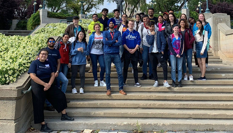 A collection of students standing on steps smiling