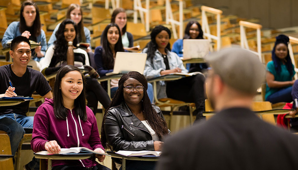 Students in a classroom with professor in the foreground