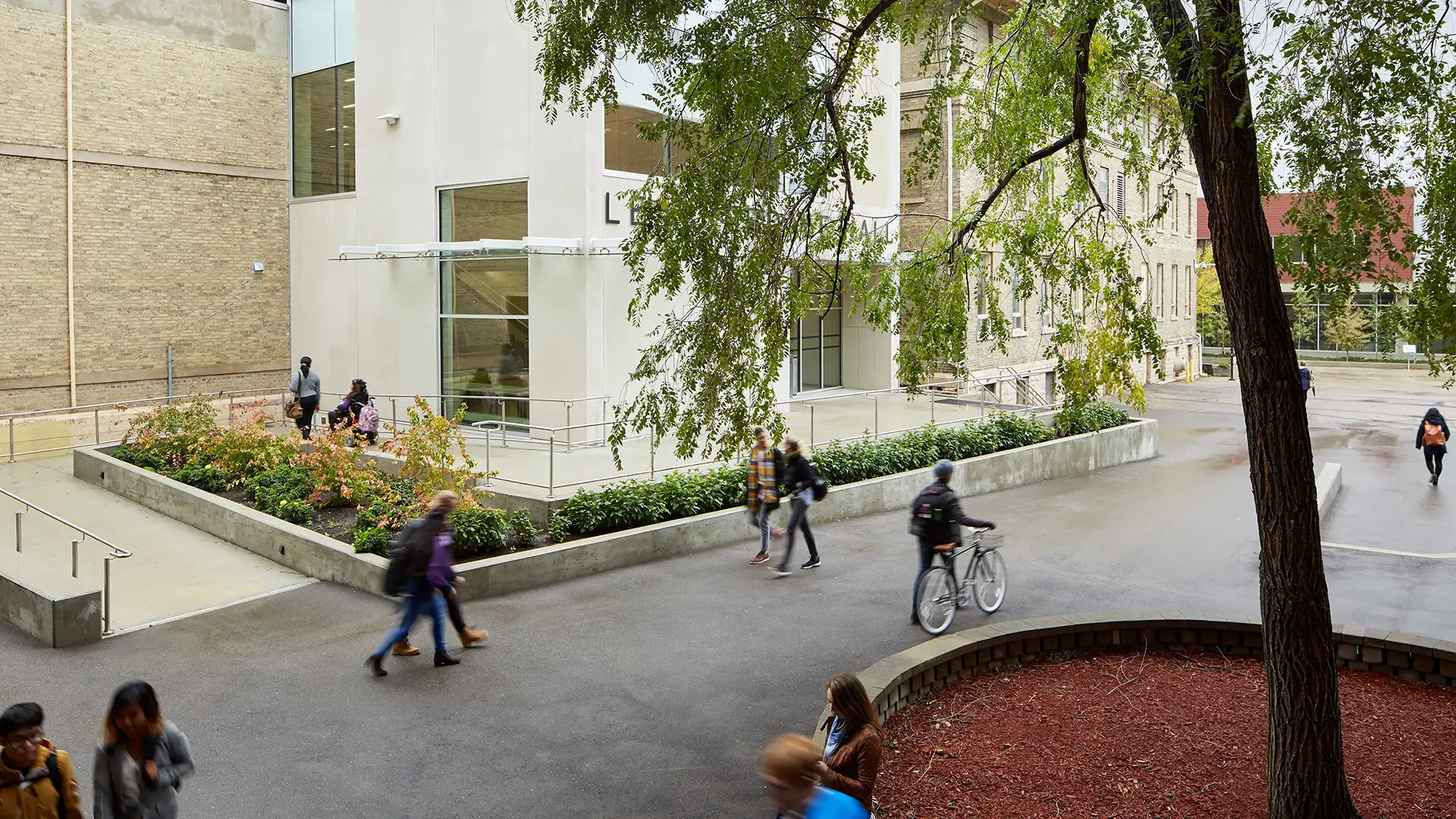 Leatherdale Hall in the fall, students walking 