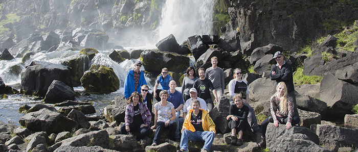 Trip participants posing on tectonic plate boundary in Iceland