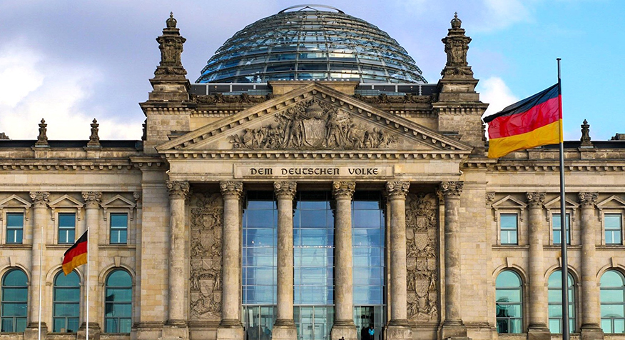 The German Parliament building with German flags.