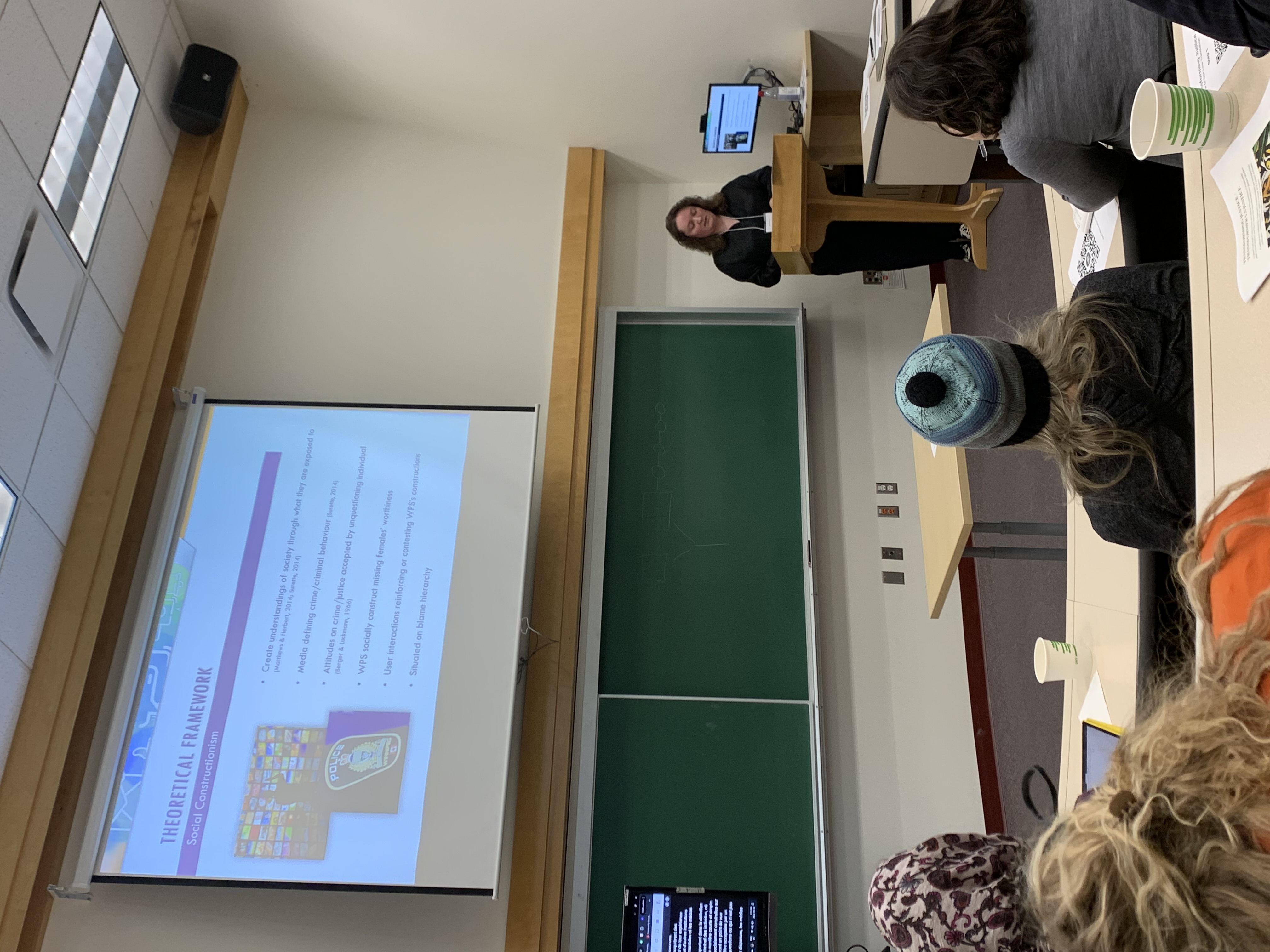 Elise Diplock presenting her research in front of a room