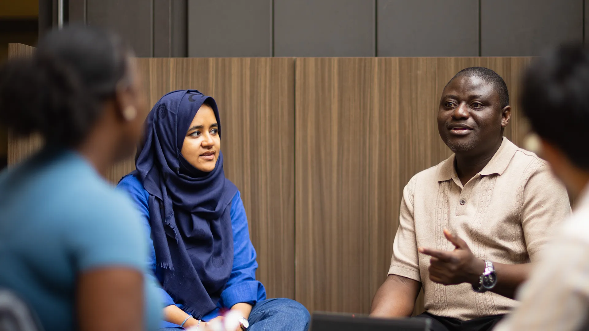 Two Students Talking at a desk