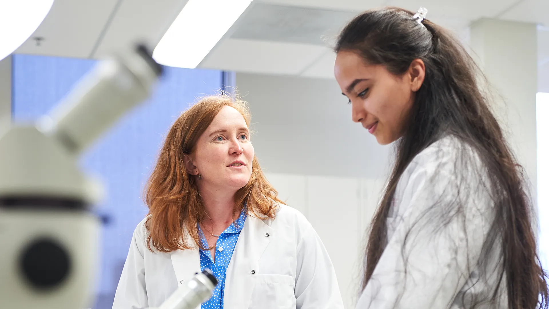 Two women talking in a lab