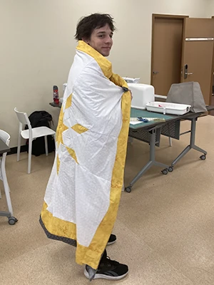 Tyrone wearing his yellow and white star blanket 