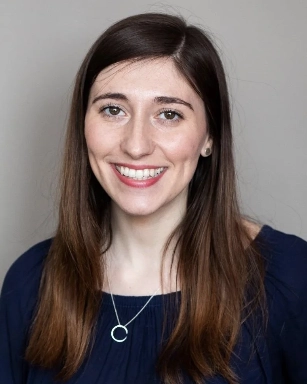 A headshot of Dr. Bev Fredborg in front of a grey background.