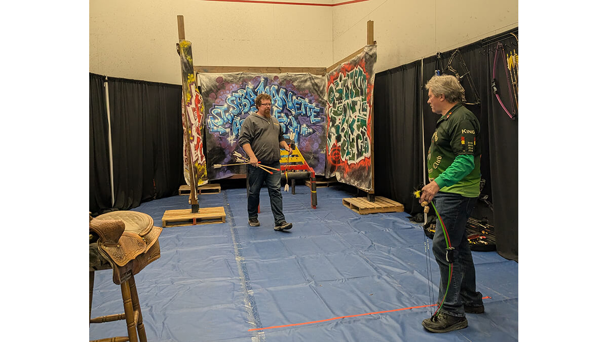 Two people with bow and arrows